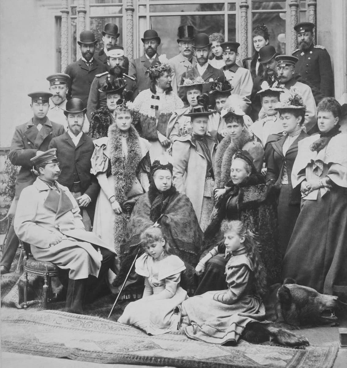 Queen Victoria surrounded by her family at Coburg, April 1894. Public-domain photograph.