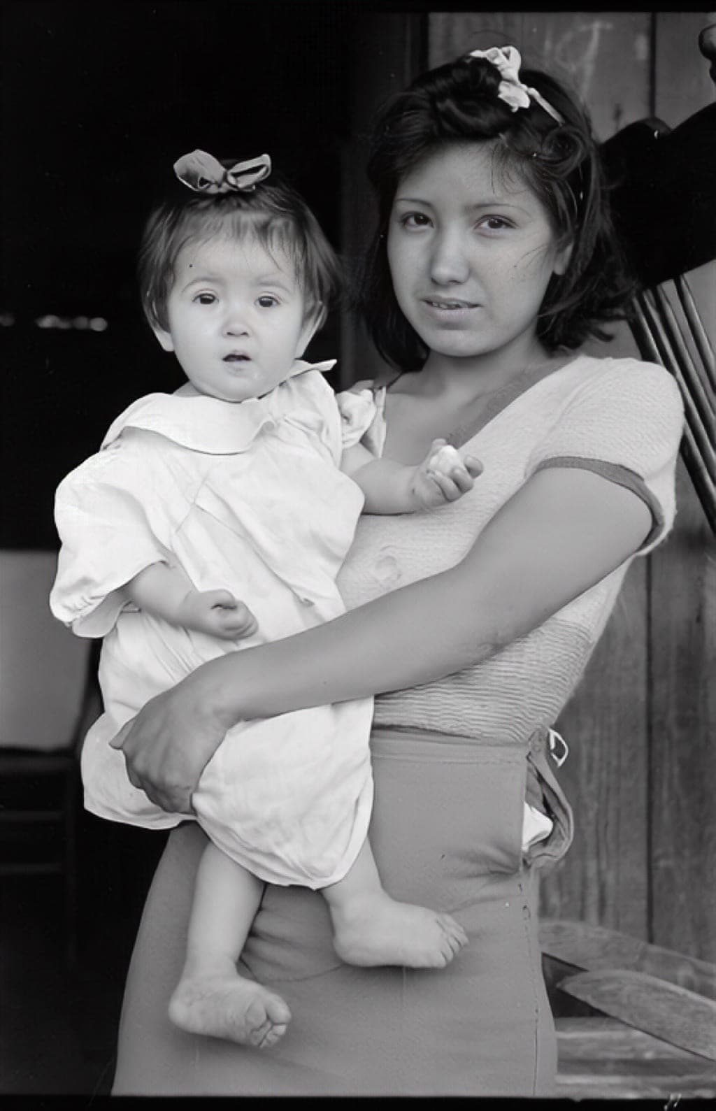 Public-domain demonstration photograph of a young woman holding a small child